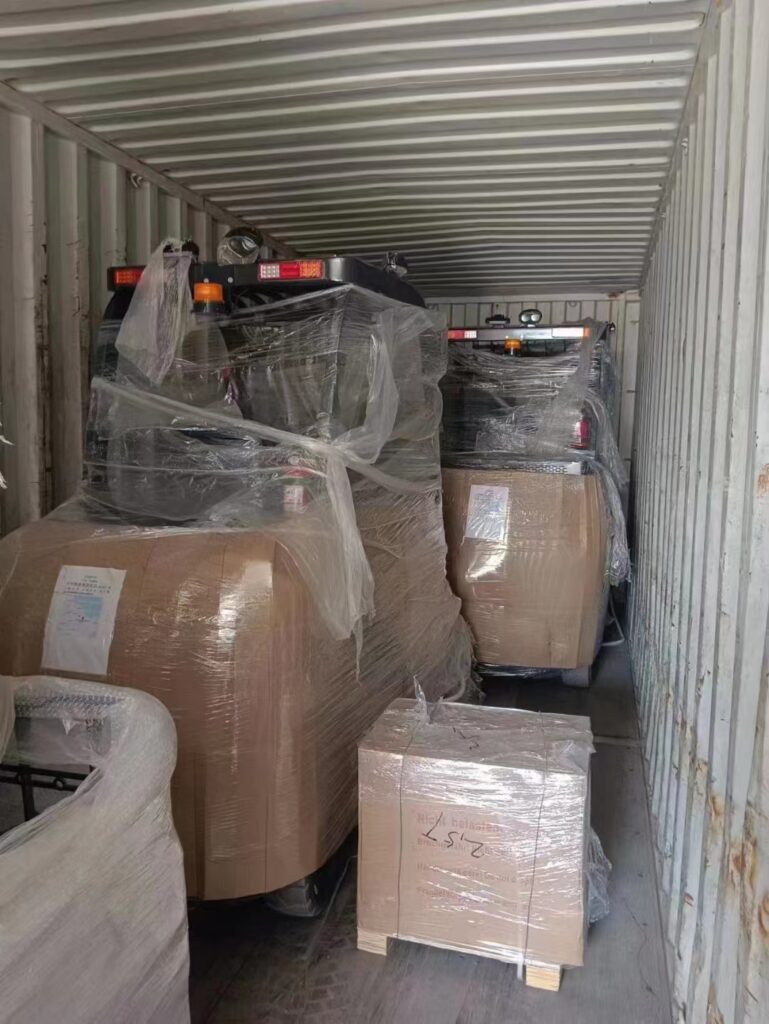 Wrapped forklifts inside a shipping container — packing example
